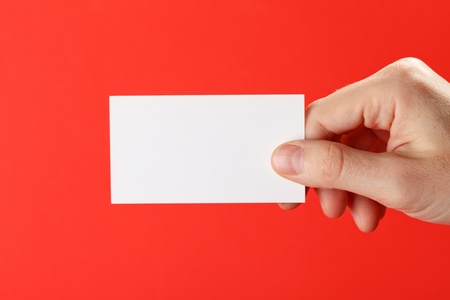 businessman's hand holding blank white paper business cardの写真素材