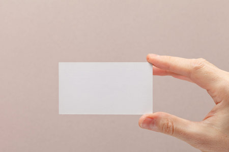 businessman's hand holding blank white paper business card