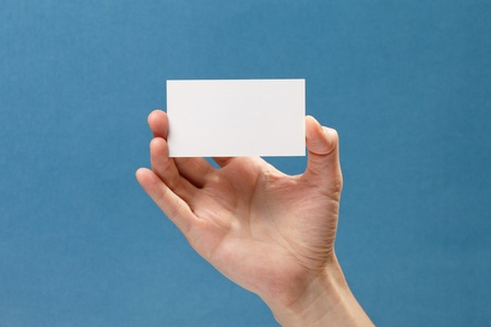 businessman's hand holding blank white paper business cardの写真素材