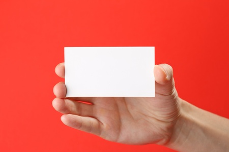 businessman's hand holding blank white paper business cardの写真素材
