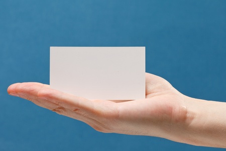 businessman's hand holding blank white paper business cardの写真素材
