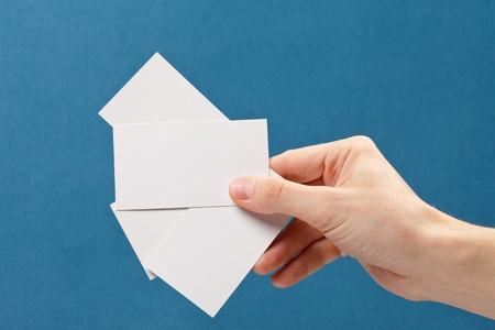 businessman's hand holding blank white paper business cardの写真素材
