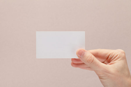 businessman's hand holding blank white paper business cardの写真素材