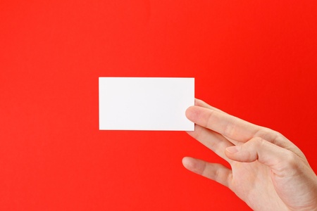 businessman's hand holding blank white paper business cardの写真素材