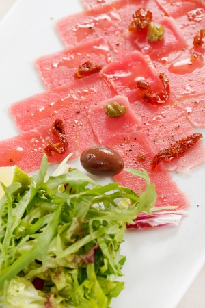 Fish Carpaccio with olives ana saladの写真素材
