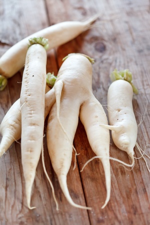 Daikon radish on the wood background の写真素材