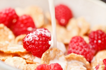 Cornflakes with milk and raspberries の写真素材