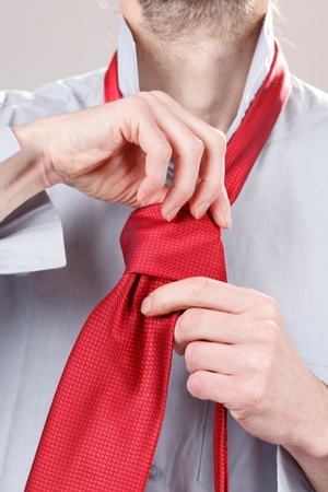 Man adjusting tie の写真素材