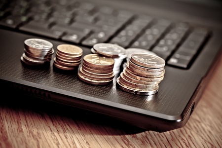 coins on the laptopの写真素材