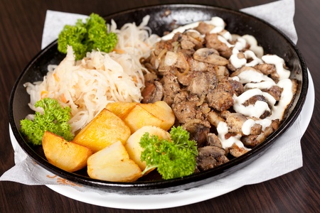 meat with potatoes in the potの写真素材