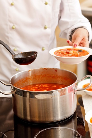 chef cooking solyanka in kitchenの写真素材