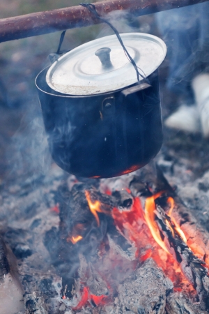 Preparing food on campfireの写真素材