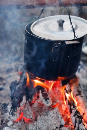 Preparing food on campfireの写真素材