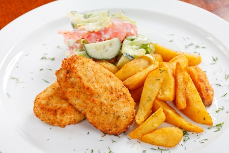 chicken cutlet with fried potatoesの写真素材