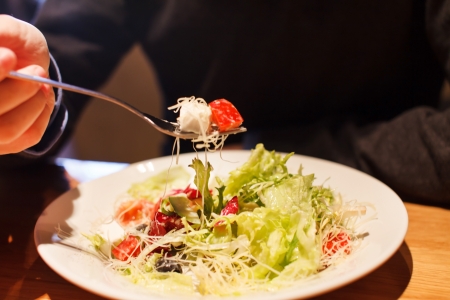man eating fresh saladの写真素材