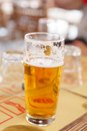 Ice cold beer. Tall frosty glass of cold beer in outdoorの写真素材