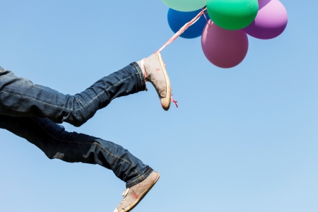 flying legs with balloonsの写真素材