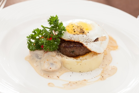 fried egg with steak and potatoesの写真素材