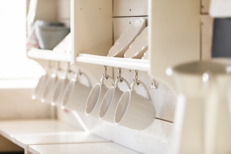 opened cupboard with kitchenware insideの写真素材