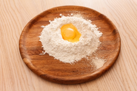 Broken egg on flourの写真素材