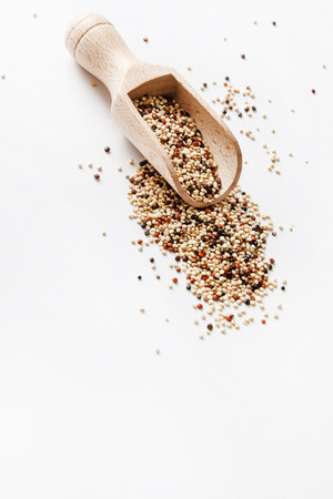 quinoa seed grain in a wooden bowl scoopの写真素材