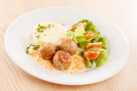meat balls with mashed potatoes and vegetablesの写真素材