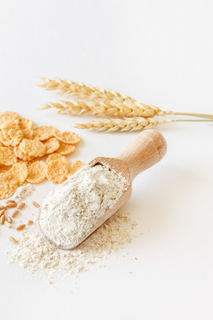 wholemeal flour in wooden spoonの写真素材