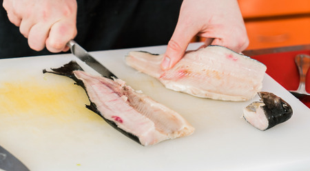 chef cutting fishの写真素材