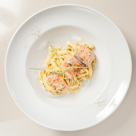 tasty pasta with cream, salmon and cheeseの写真素材