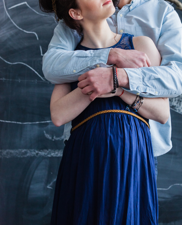 Man embraces his pregnant womanの写真素材