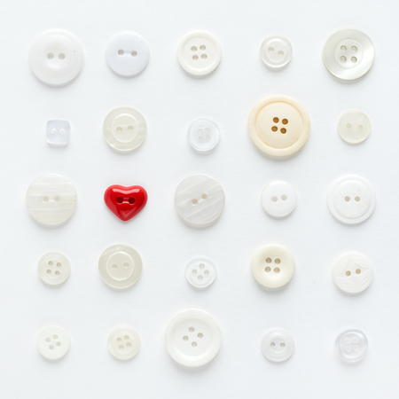 white buttons with red heartの写真素材