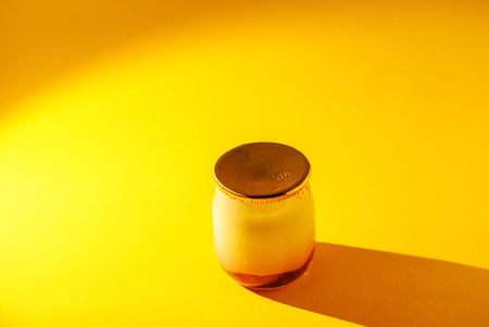 a glass jar with yogurt の写真素材