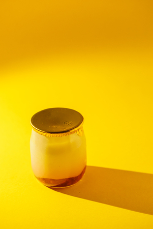a glass jar with yogurt の写真素材