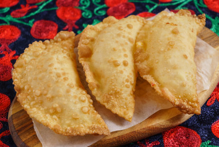 Chebureks with meat, on a wooden board