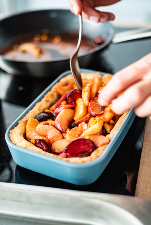 chef making plum pieの写真素材