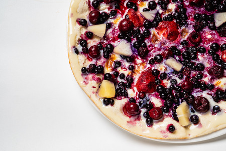 pizza with berries and fruits on the white backgroundの写真素材