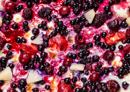 pizza with berries and fruits on the white backgroundの写真素材