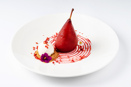 Red wine poached pear on the white backgroundの写真素材