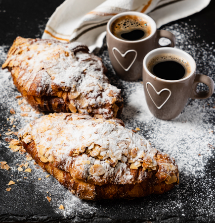Croissants with almonds on the black backgroundの写真素材