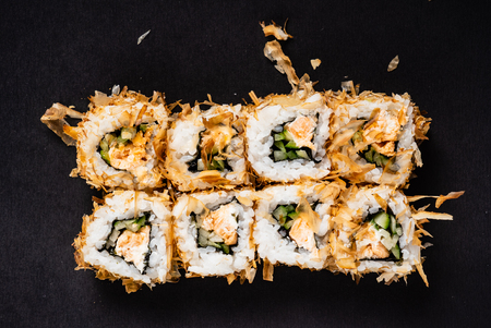 Sushi rolls set served on black stone slate on darkの写真素材