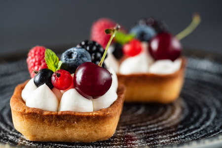 Fresh homemade fruit tart with cherry, blueberres and raspberriesの写真素材