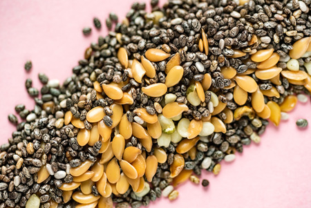 Healthy superfood:  flax seeds, chia seeds and hemp shelled seed on pinkの写真素材