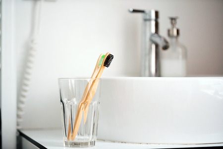 Eco natural bamboo toothbrushes in glass. sustainable lifestyle concept.の写真素材