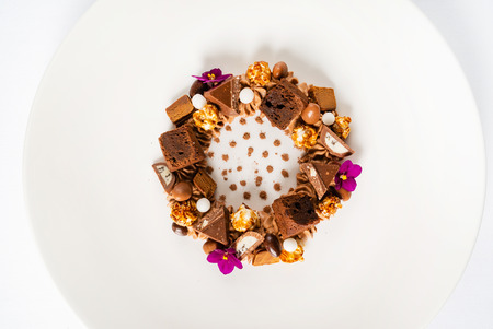 creative dessert with brownie and edible flowersの写真素材