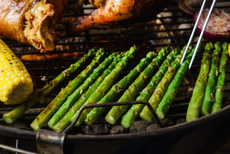 Grilling asparagus on a summer dayの写真素材