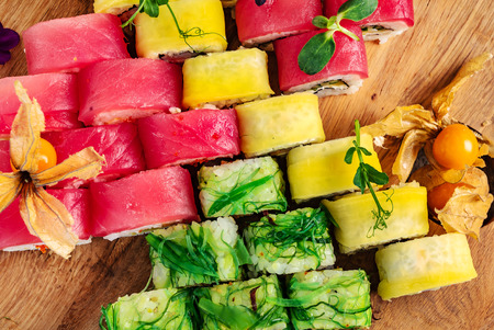 Rainbow Sushi Roll with salmon, eel, tuna, avocado, royal prawn, cream cheese Philadelphia, caviar tobica, chuka. Sushi menu.の写真素材