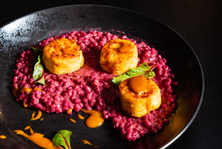 Risotto with beetroot and scallopsの写真素材