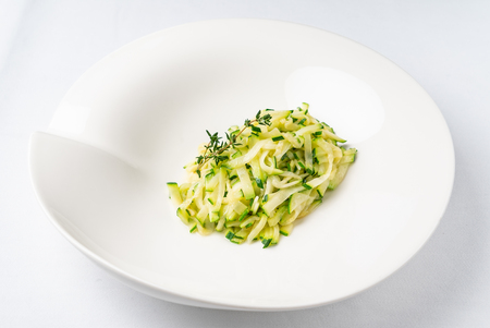 zucchini pasta with thyme on the white plateの写真素材