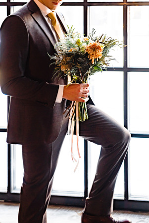 elegant groom with flowersの写真素材