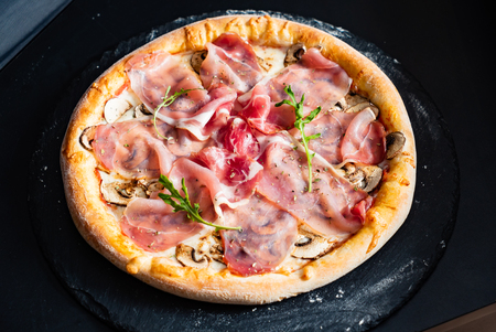 pizza with ham and mushroomsの写真素材